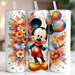 May include: A white tumbler featuring a colourful autumnal floral design and a cartoon Mickey Mouse character. The tumbler comes with a straw and a lid.