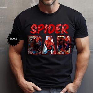May include: Black t-shirt with the words "SPIDER DAD" in red, featuring a Spider-Man graphic. The word "SPIDER" is in a web-like font. The word "DAD" has a comic book style design with Spider-Man images.
