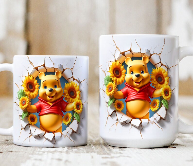 May include: Two white ceramic mugs with a Winnie the Pooh design. The mugs feature a 3D Winnie the Pooh character peeking out of a cracked wall with sunflowers surrounding him. The smaller mug has a handle on the left side, while the larger mug has a handle on the right side.