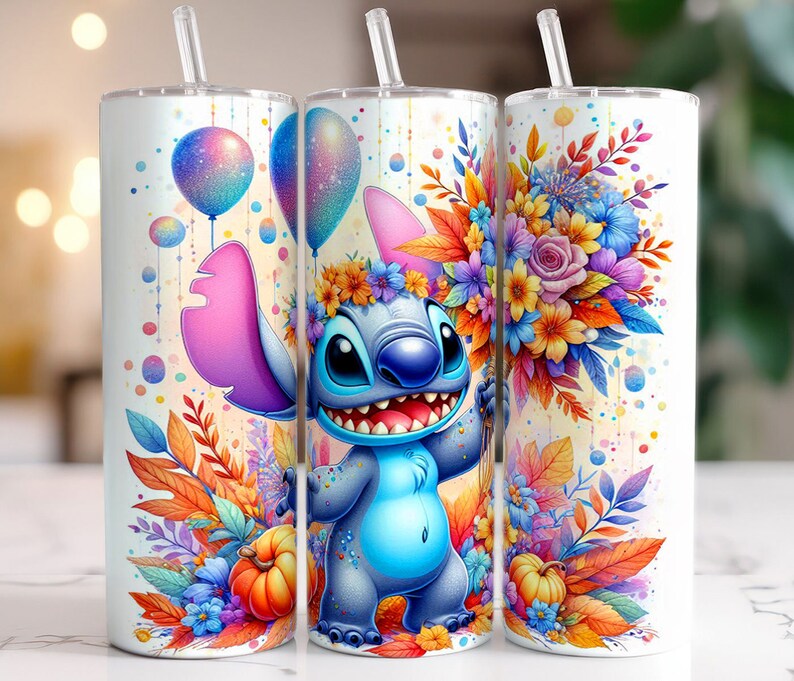 May include: A white tumbler featuring a blue Stitch character from Lilo & Stitch. Stitch is holding a bouquet of colourful flowers and balloons. The tumbler has a straw and is decorated with a watercolour-style background.