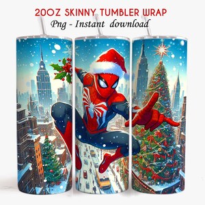 May include: A 20oz skinny tumbler wrap depicting a winter cityscape with a Christmas tree and Spider-Man in a Santa hat. The tumbler has a white straw and the text "20OZ SKINNY TUMBLER WRAP Png - Instant download".