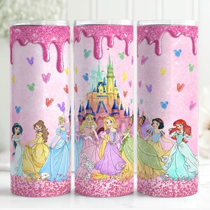 May include: A pink glitter tumbler with a pink and white dripping glaze design. The tumbler features a scene of Disney princesses in front of Cinderella's castle with Mickey Mouse balloons.