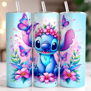 May include: A blue and pink stainless steel tumbler with a floral design and a cartoon Stitch character. The tumbler features a blue Stitch character with a flower crown, surrounded by pink flowers and butterflies.