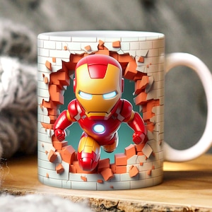 May include: A white ceramic mug with a 3D image of Iron Man breaking through a brick wall. The mug has a handle on the right side.