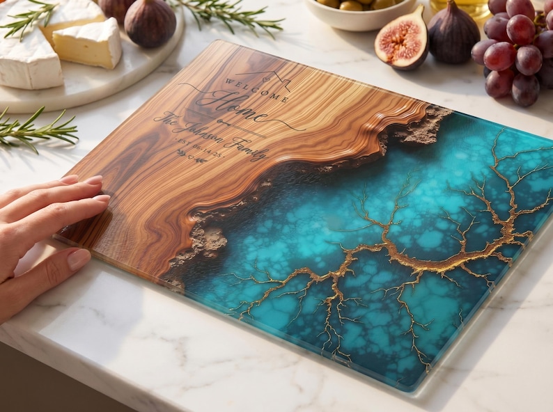 May include: A rectangular wooden cutting board with a turquoise resin design. The board features the text "Welcome Home" and a family name. The board is surrounded by cheese, figs, and grapes.