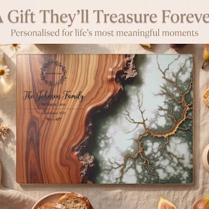 May include: A personalized wooden cutting board with a unique design. The board features a wood grain pattern on one side and a decorative design on the other. Text on the board reads "The Johnson Family" and "14 Maple Lane". The image also includes flowers, bread, and coffee.