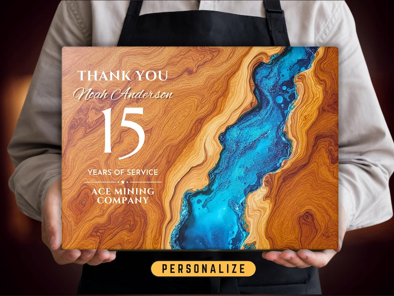 May include: A wooden plaque with a blue and brown abstract design. The plaque says "Thank You Noah Anderson 15 Years of Service Ace Mining Company".