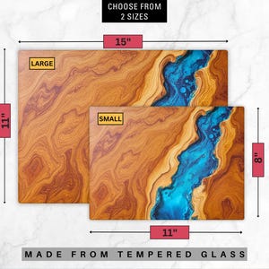 May include: Two cutting boards made of tempered glass with a wood grain pattern and a blue resin river running through the center. The larger board is 15 inches by 11 inches and the smaller board is 11 inches by 8 inches.