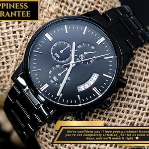 May include: A black analog wristwatch with a matching black metal link band. The watch face is black with white hour markers, three sub-dials, and a date window. Text on the image reads HAPPINESS GUARANTEE and includes a satisfaction policy.