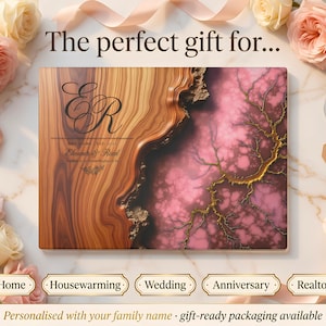 May include: A personalized wooden plaque with a brown and pink marbled design, featuring the initials "ER" and the names "Eleanor & Reed". The plaque is surrounded by roses and ribbons, with text that reads "New Home", "Housewarming", "Wedding", "Anniversary", and "Realtor Gift".