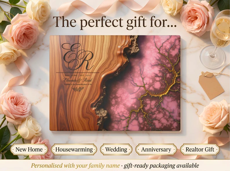 May include: A personalized wooden plaque with a brown and pink marbled design, featuring the initials "ER" and the names "Eleanor & Reed". The plaque is surrounded by roses and ribbons, with text that reads "New Home", "Housewarming", "Wedding", "Anniversary", and "Realtor Gift".