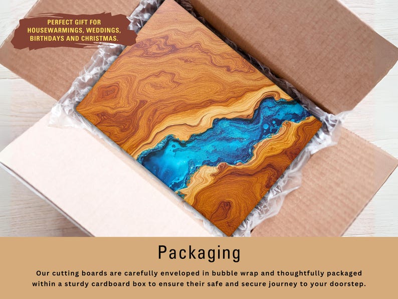 May include: A wooden cutting board with a blue resin inlay. The board is packaged in a cardboard box with bubble wrap for protection. The text "PERFECT GIFT FOR HOUSEWARMINGS, WEDDINGS, BIRTHDAYS AND CHRISTMAS." is printed on the box.
