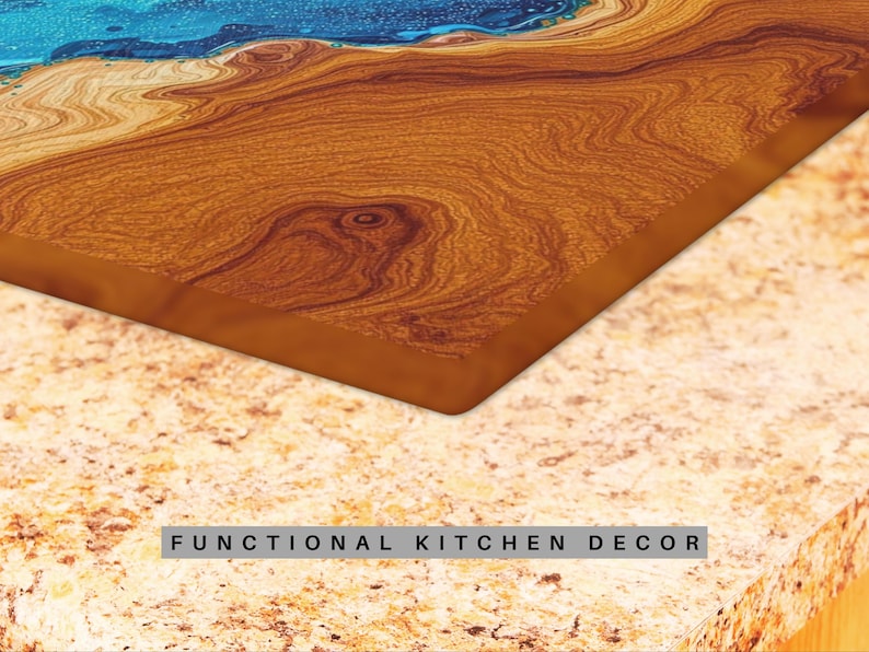 May include: A close-up of a wooden cutting board with a blue epoxy resin inlay. The board has a natural wood grain pattern and is a functional kitchen decor item.