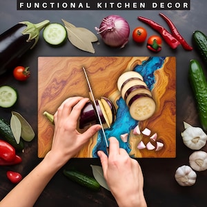 May include: A wooden cutting board with a blue and brown epoxy resin inlay. A person is using a knife to cut an eggplant on the board. There are also some garlic cloves and eggplant slices on the board.