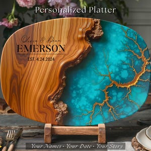 May include: Personalized wooden serving platter with a turquoise and gold resin inlay. The platter has a natural wood grain finish and is engraved with the text "Olive & Dean Emerson EST. 4.24.2024".