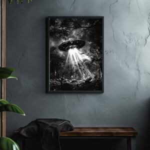 May include: A black and white photograph of a UFO hovering over a forest. The UFO is emitting a bright light that illuminates the trees below.