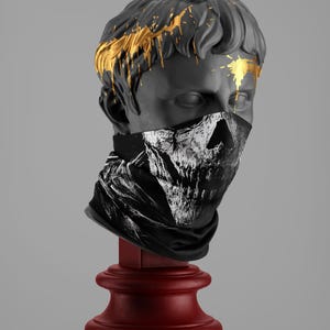 May include: A plaster bust of a man with gold paint dripping down his face, wearing a black and white skull bandana.