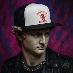 May include: A black and white trucker hat with a white front panel featuring a red cartoon devil holding a pitchfork and the text "Satan's Little Helper".