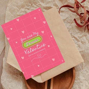 May include: Pink Valentine's Day card with a grid pattern and white hearts. The card says "You are my forever Valentine and my favorite headache."
