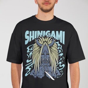 Male model confidently showcasing anime-themed streetwear T-shirt design.