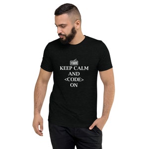 May include: Black t-shirt with white text that reads "Keep Calm and <CODE> ON". A small keyboard icon is above the text.