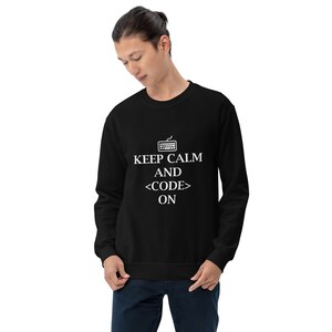 May include: Black sweatshirt with the text "KEEP CALM AND <CODE> ON" in white. The design includes a keyboard icon above the text. The sweatshirt is a crew neck style.