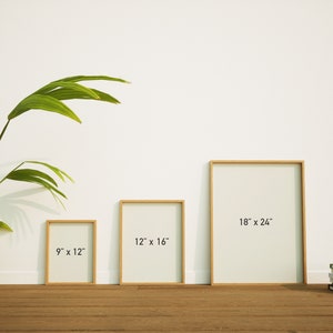 May include: Three framed art prints of varying sizes: 9 x 12 inches, 12 x 16 inches, and 18 x 24 inches. Each print has a light-colored interior and a natural wood frame. The frames are displayed on a wooden floor against a white wall.