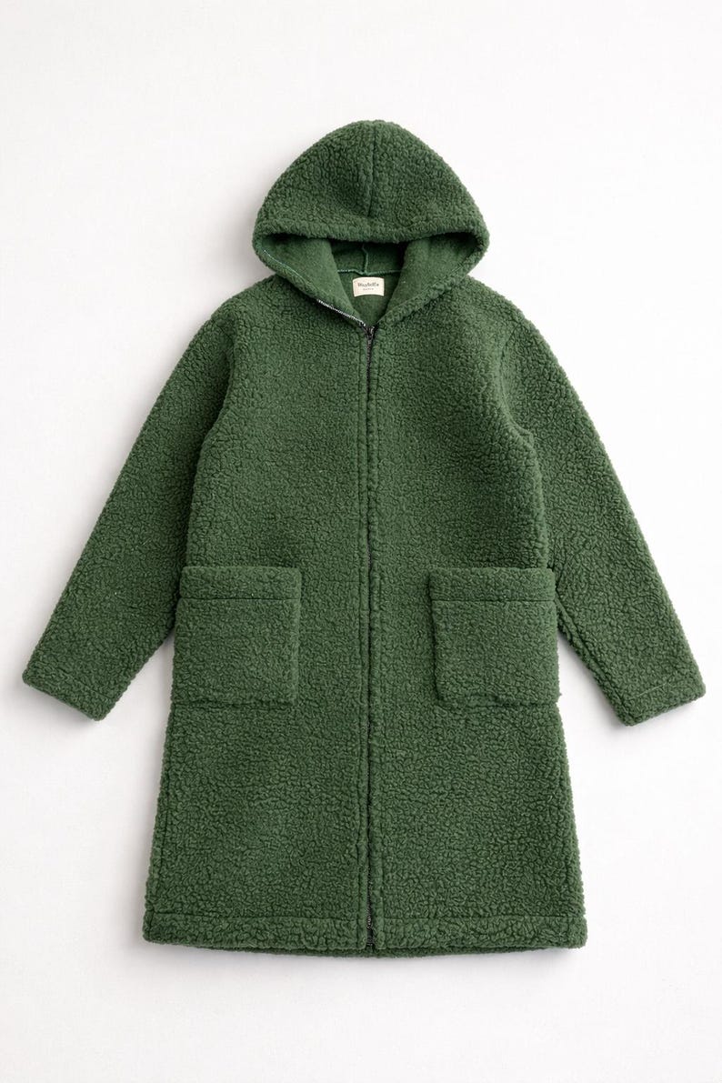 May include: A forest green long-sleeve coat made of textured sherpa fleece material. This hooded coat features a full-length front zipper closure, two large square patch pockets on the front, and a straight hemline that reaches mid-thigh length.
