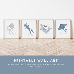 May include: Set of four printable wall art prints featuring watercolor illustrations of ocean animals. The prints depict a jellyfish, a hammerhead shark, a whale, and a stingray. The prints are framed in natural wood frames and are ready to hang.