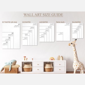 May include: A wall art size guide with different ratios and measurements in inches and centimeters. The guide shows the dimensions of various sizes of wall art, including 5:7, 2:3, 4:5, 11x14 inch, and 3:4 ratios. The guide is displayed on a white wall with a white dresser and a stuffed giraffe toy.