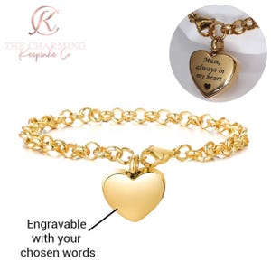 May include: A gold-coloured bracelet featuring a heart-shaped pendant. The bracelet has a chain-link design and a lobster clasp. The heart pendant is engravable and the image shows the text "Mum, always in my heart".