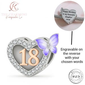 May include: A silver charm in the shape of a heart, with the number 18 in gold and a purple butterfly. The heart is adorned with clear crystals. The charm is engravable on the reverse.