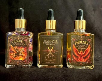 May include: Three rectangular glass bottles with gold dropper caps containing yellow oil and dried flowers. The labels read Closure Ritual Oil Moving On, Severance Cord Cutting Ritual Oil, and Phoenix Ritual Oil The Comeback Rebirth Witch Elixir.