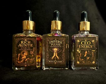 May include: Three square glass bottles with gold dropper caps containing clear liquid and botanical elements. The labels feature ornate gold borders and text: Rich Auntie Ritual Oil, Universe Please Manifestation Oil, and CEO Energy Career Ritual Oil.