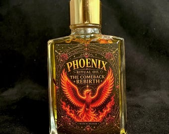 May include: A clear glass dropper bottle filled with golden liquid, featuring a rectangular label with a fiery phoenix illustration and the text PHOENIX RITUAL OIL THE COMEBACK REBIRTH WITCH ELIXIR. The bottle has a gold-colored collar and black dropper.