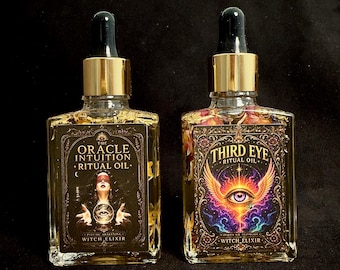 May include: Two rectangular glass bottles with gold dropper caps containing clear oil and dried flower petals. The left label reads The Oracle Intuition Ritual Oil Witch Elixir. The right label reads Third Eye Ritual Oil Witch Elixir.