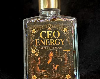 May include: A clear glass bottle with a gold dropper cap containing liquid and dried botanicals. The black label features gold text reading CEO ENERGY CAREER RITUAL OIL WITCH ELIXIR, with an illustration of a person at a desk with a laptop.