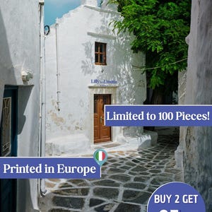 May include: A white building with a brown door and a bell tower. The building is located in a narrow alleyway with a cobblestone floor. The text "Limited to 100 Pieces!" is visible in the image. The text "Printed in Europe" is also visible in the image. The image is a photograph of a building in a European city.