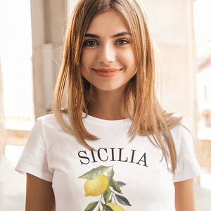 May include: A white t-shirt with a lemon graphic and the text "SICILIA Italy" printed on the front.