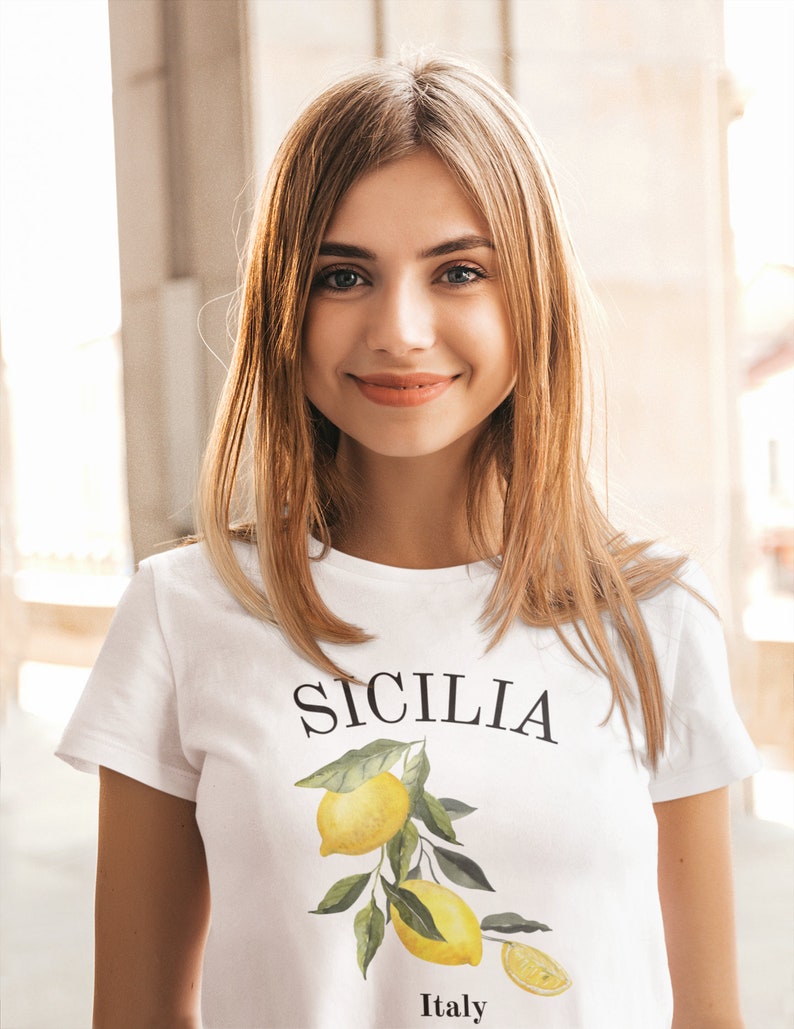 May include: A white t-shirt with a lemon graphic and the text "SICILIA Italy" printed on the front.