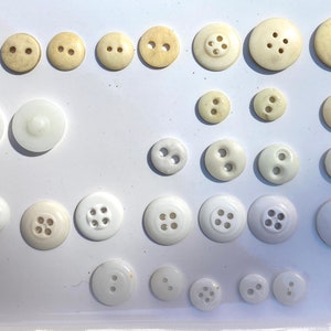 A collection of white and cream buttons from early 1900&#39;s and before