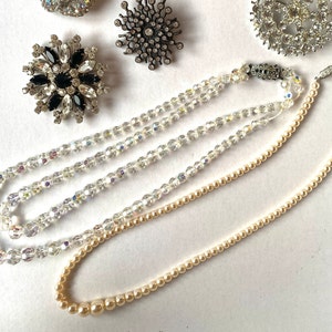 Honey coloured imitation pearl necklace with decorative fish hook fastening