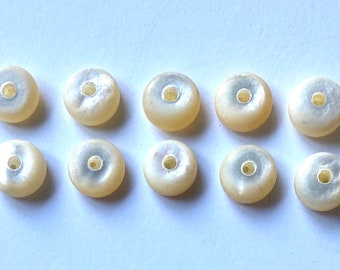 Eighteen beautiful domed Mother of Pearl buttons with two thread holes on one side and one thread hole on the other