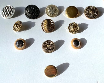 A collection of metallic, plastic and metal buttons from 20th Century