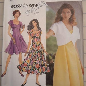 May include: Simplicity sewing pattern 7873, featuring illustrations of dresses. The pattern includes a purple dress, a floral dress, and a yellow dress with a white bolero. The text "easy to sew" is visible.