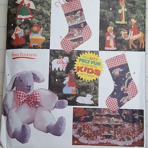 May include: A Simplicity Holiday pattern collection featuring felt ornaments kids can make. The image shows a plush bunny, Christmas stockings, and felt ornaments of angels, the nativity scene, and sheep.
