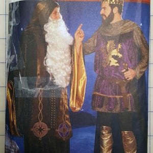 May include: Simplicity Medieval Costume Collection pattern. The image shows two medieval costumes. One is a dark robe with a white beard and the other is a purple and gold tunic with a crown and gold boots. The pattern number is 9753.