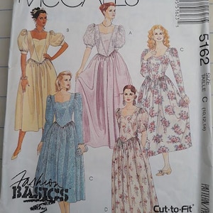 May include: McCall's sewing pattern envelope featuring illustrations of vintage dresses. The dresses are in various colors and styles, including floral prints and solid colors. The text "Fashion Basics" is visible, along with size information.