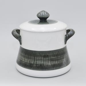 Puede incluir: Plato de servir de cerámica blanca con un patrón de hojas en blanco y negro. El plato tiene dos asas y una tapa con un pomo.