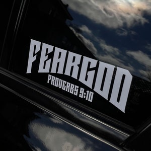 May include: White vinyl decal with the words "Fear God" in bold, stylized lettering. Below the words is the text "Proverbs 9:10".